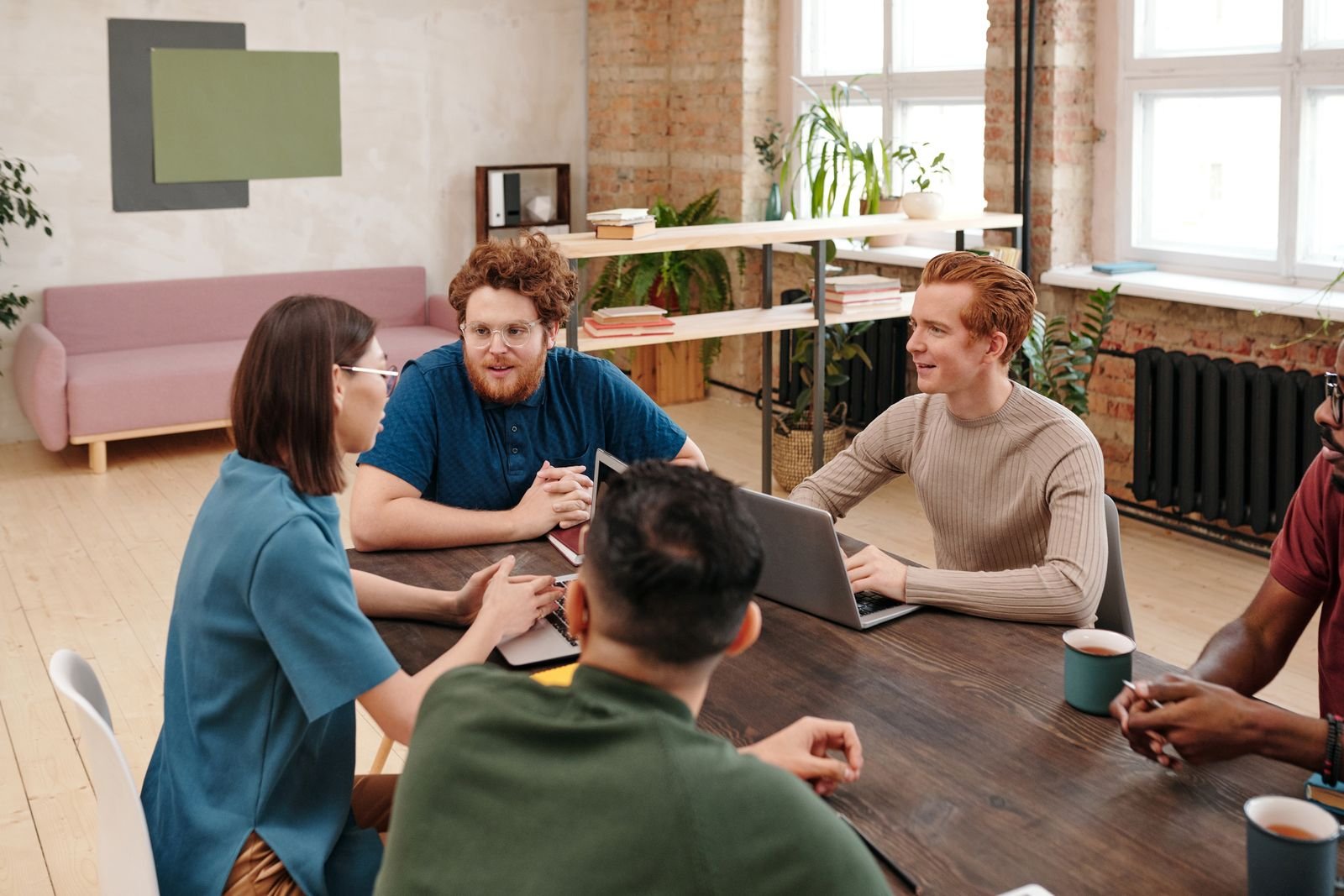 Colleagues exchanging perspectives in a bright workplace